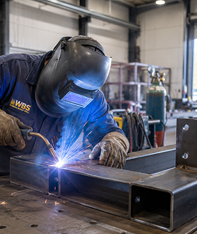 Welder joining steel with sparks